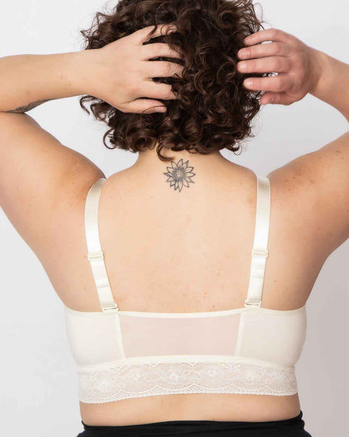 Ivory / Implants & longline pullover bra with a lace trim, soft cups, mesh back, adjustable straps on au natural model.