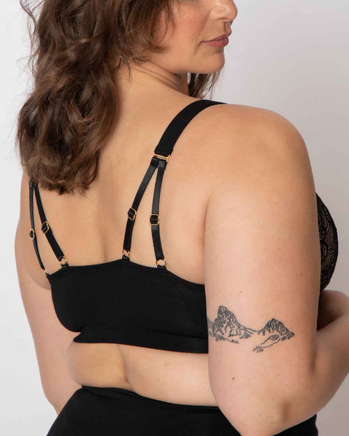 Black / Implants & pocketed front closure lace bra made with soft modal, dual adjustable back straps and underwire free cups on implant reconstruction model.