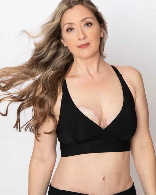 Black / Mastectomy & pocketed wrap sports bra with racerback, back closure and adjustable straps on mastectomy model with breast forms.