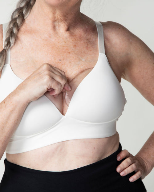 Clear & subtle shaper in bra with model pulling shaper out of bra