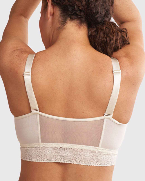 Ivory / Implants & longline pullover bra with a lace trim, soft cups, mesh back, adjustable straps on au natural model.