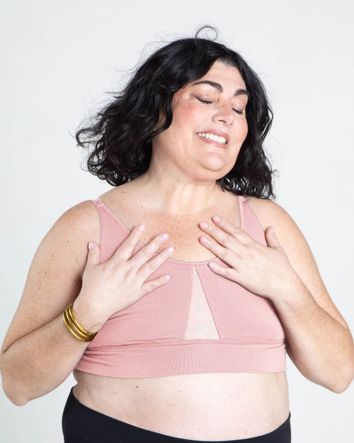 Blush / Flat & pocketed leisure lounge bra with mesh side panels and underwire free designs on model front view