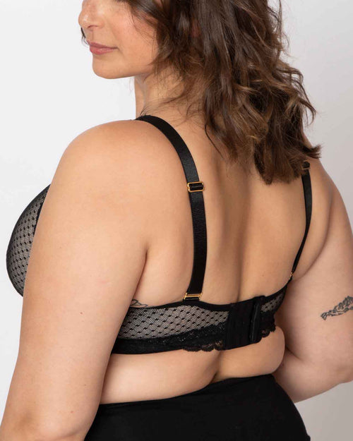 Black / Implants & pocketed wrap front lace bralette with wireless cups, back closure and adjustable straps on implant reconstruction model.