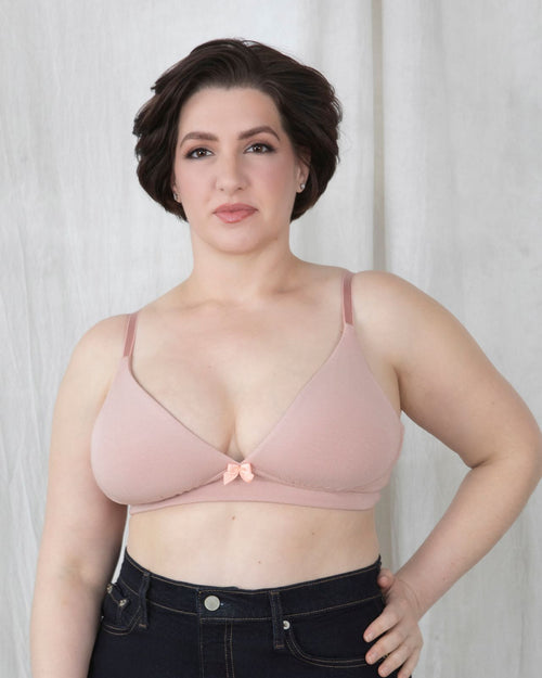 Blush / Implants & pocketed plunge t-shirt bra with soft wire free cups, back hook closure and adjustable straps on model.
