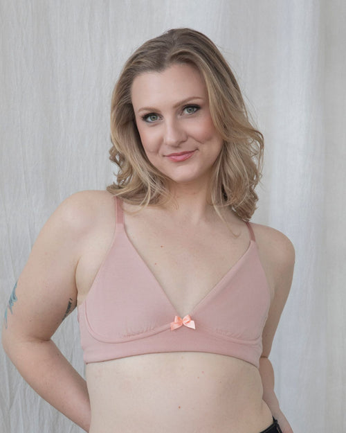 Blush / Implants & pocketed plunge t-shirt bra with soft wire free cups, back hook closure and adjustable straps on model.