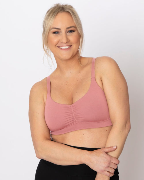 Blush / Mastectomy & pocketed full coverage t-shirt bra with soft wire free cups, back hook closure and adjustable straps on model.