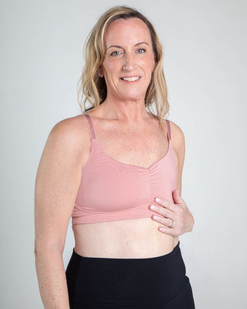 Blush / Mastectomy & pocketed full coverage t-shirt bra with soft wire free cups, back hook closure and adjustable straps on model.