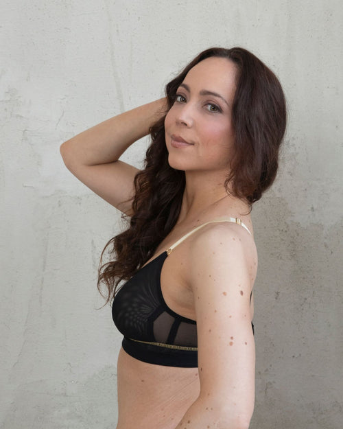 Blush / Au Natural & model wearing the Victoria Pocketed Keyhole bralette with gold lace trim and gold jewel that says anaono side view