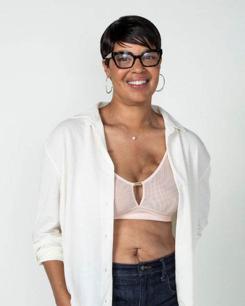 Blush / Au Natural & model wearing the Victoria Pocketed Keyhole bralette with gold lace trim and gold jewel that says anaono side view