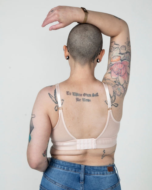 Blush / Au Natural & model wearing the Victoria Pocketed Keyhole bralette with gold lace trim and gold jewel that says anaono side view