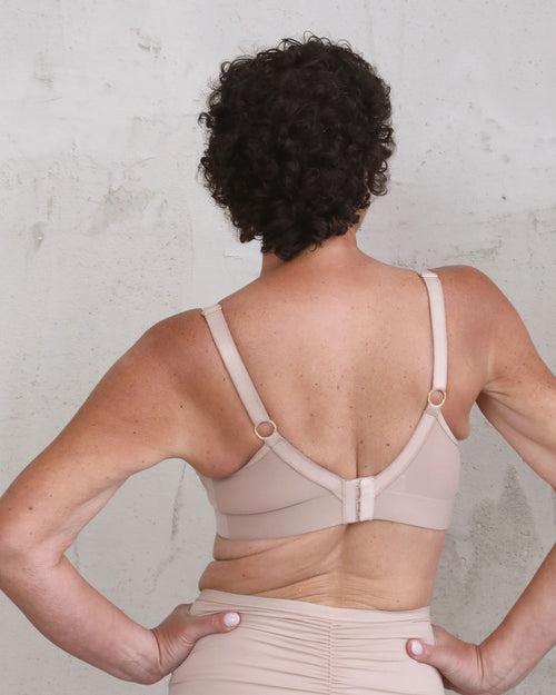Latte / Implants & Front chest view of the Brenda Pocketed Mesh Bra in latte, featuring a sheer V-neckline and a smooth, sheer wire-free plunge bra silhouette.