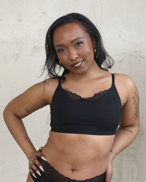 Black / Flat & Front view of the Tammi full coverage lace bralette in black, showing the feminine lace trim neckline and smooth, wire-free fit.