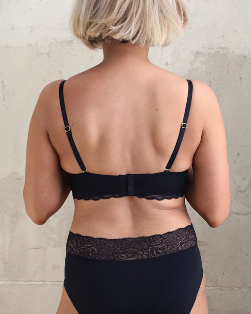 Black / Flat & Front view of the Tammi full coverage lace bralette in black, showing the feminine lace trim neckline and smooth, wire-free fit.
