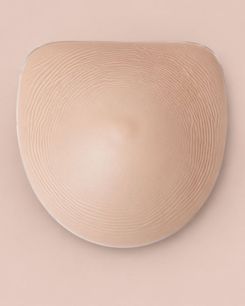 Honey & heart flex silicone breast forms in the honey flat lay