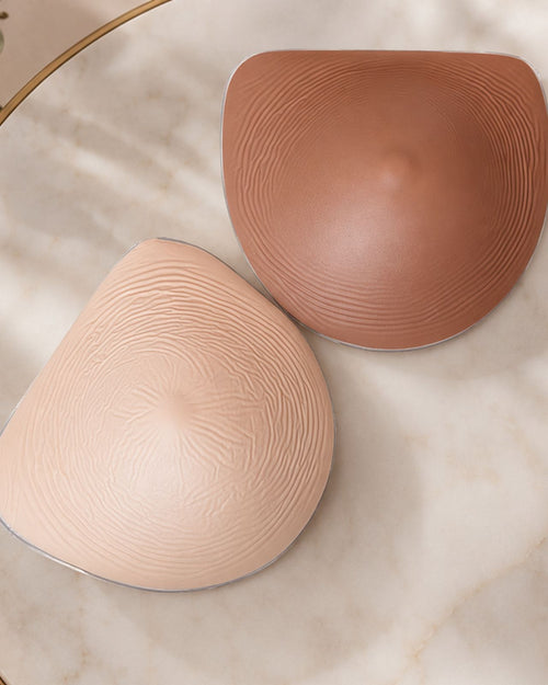 Honey & heart flex silicone breast forms in the honey and maple flat lay 