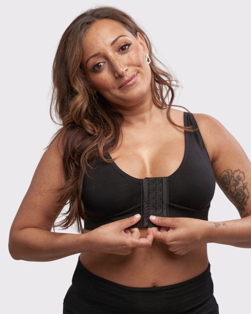 Black & pocketed front closure mastectomy bra with soft modal material and convertible & adjustable straps on model. The AnaOno Rora bra is a great option for recovering after a breast or chest surgery.