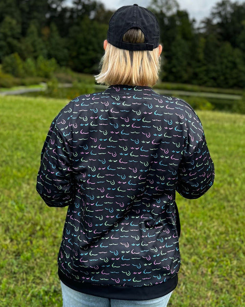 Black & breast cancer survivor wearing the limited edition metastatic breast cancer awareness bomber jacket back view