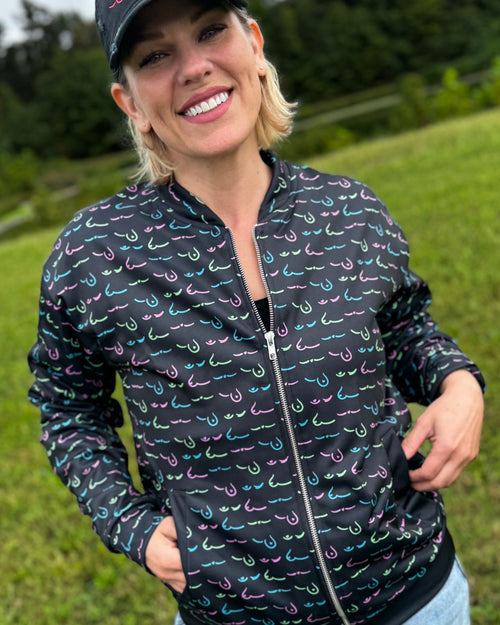 Multi & breast cancer survivor wearing the limited edition metastatic breast cancer awareness bomber jacket front view