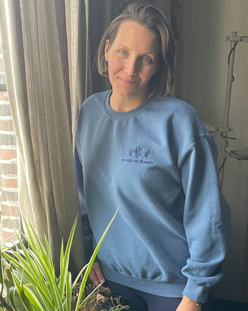 Blue & no rain, no flowers crewneck front view on model